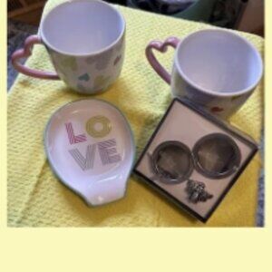 heart-printed pink cups and spoon rest, along with the cute bumble bee tea ball